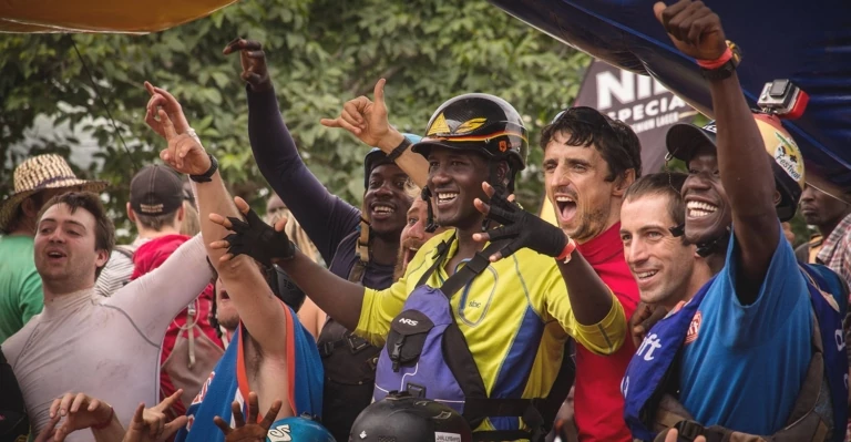 A group of kayakers (including members of the Ugandan Freestyle Kayak Team) cheer on their comrades at the Nile River Festival. Photo: Marcus Farnfield