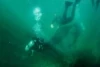 Scuba and free divers remove fiberglass hull panels from the seafloor. Photo: Nikki Brooks