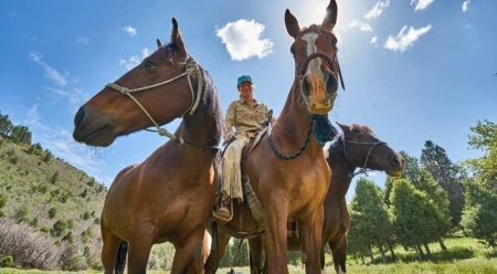 Maddy Butcher ponies two horses and rides another in southwestern Colorado. Photo: Beau Gaughran