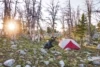 Chris Shalbot prepares breakfast near Homer Youngs Peak. Located on the shore of an unspoiled lake set beneath alpine giants it was the most beautiful and peaceful camp of the entire 11-day journey. Photo: Scott Rinckenberger