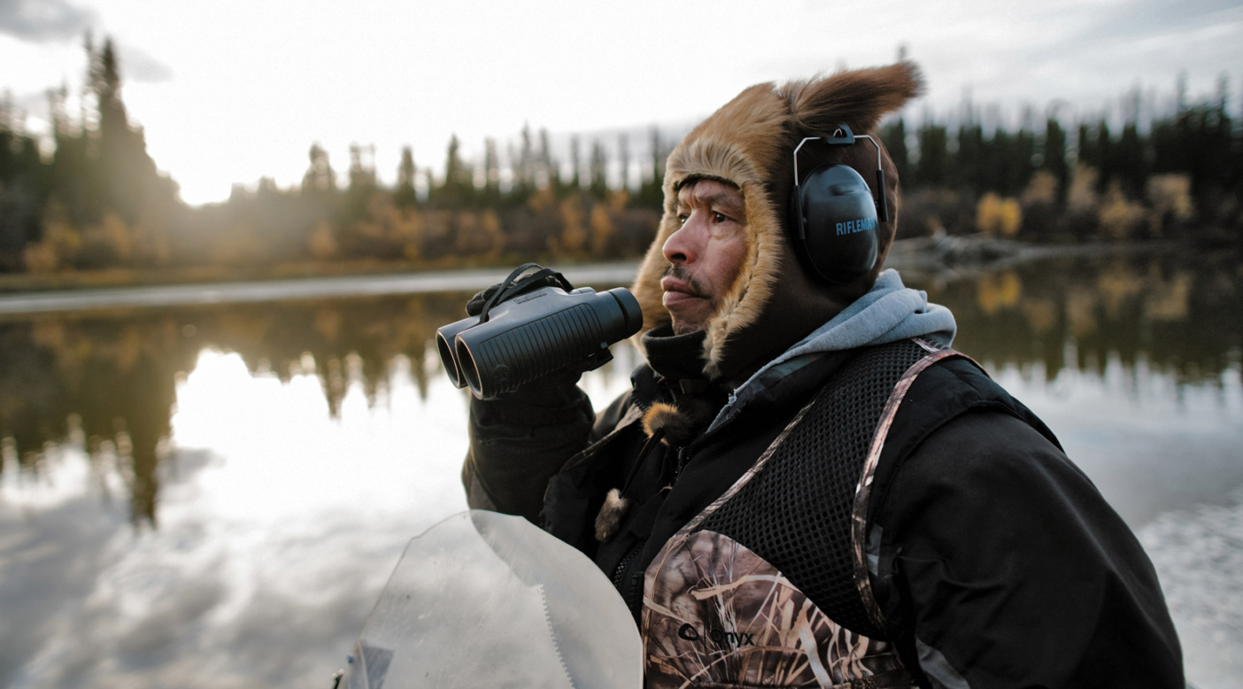 Levi Ginnis Jr. scouts the area along the Yukon River in search of moose. The hunt and the stories of Gwich'in families taking a stand to protect the Arctic National Wildlife Refuge are the main focus of the film Welcome to Gwichyaa Zhee. Photo: Greg Balkin