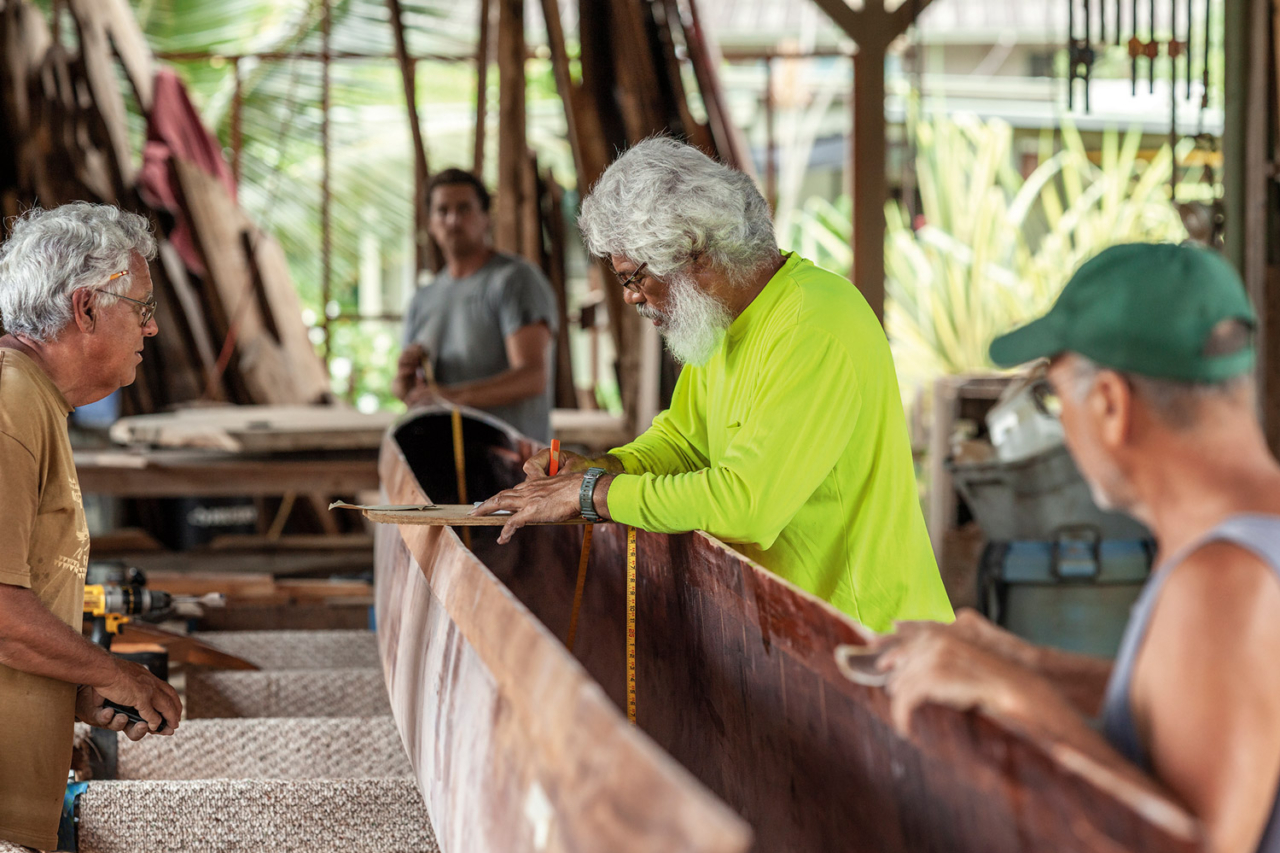 Wooden canoes are living things, with mana of their own, and working with them requires skill, understanding and respect. Uncle Myron Van Gieson puts his years of experience to work in the makeshift hālau wa’a in Hale’iwa, Hawai’i. Photo: John Bilderback