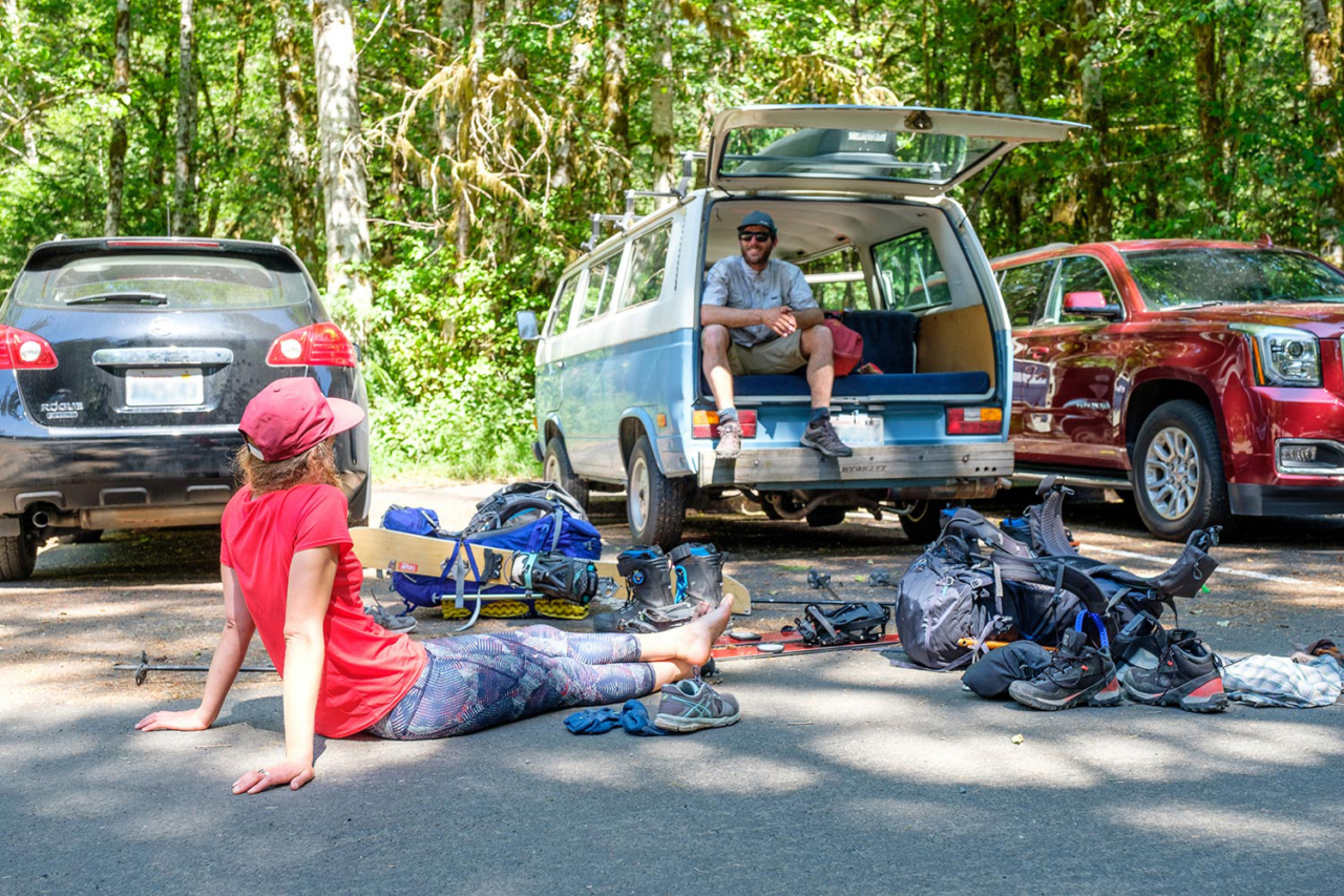 After traveling eight days and 65 miles through snowy peaks, alpine meadows, and deep rainforests, Marie-France Roy and Kael Martin take a celebratory gear explosion at the Hoh River trailhead. Photo: Colin Wiseman