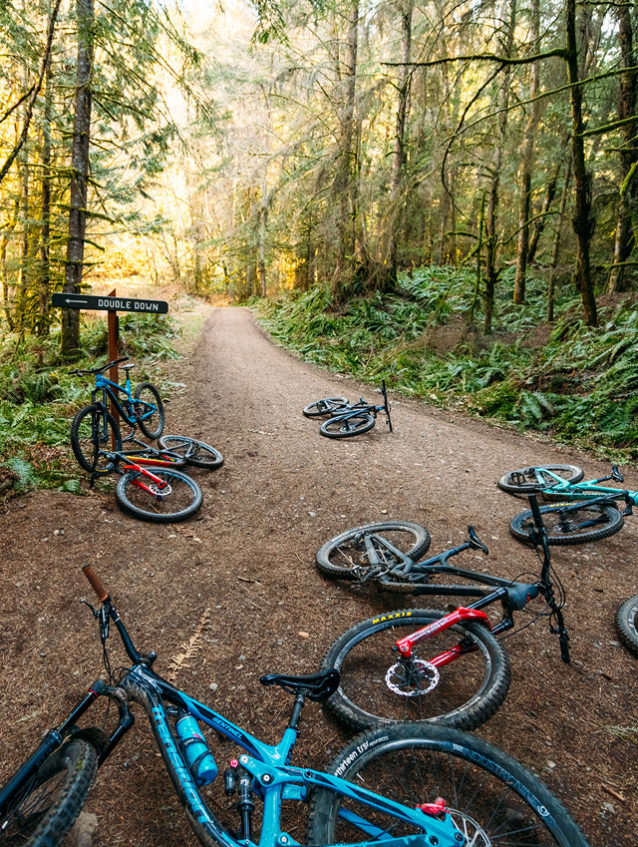 The best kind of traffic jam. A posse of bikes marks the top of Double Down while the owners survey a section of rocks and roots at the start of the trail. Photo: Paris Gore