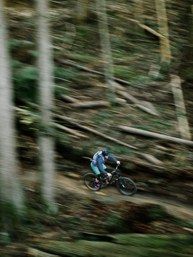 Cougar Ridge is a mix of roots, rocks and raw loam, so it’s important to let your brake fingers rest during the occasional smooth stretch. Bonnie Burke keeps it wide open on one of the trail’s high-speed sections. Photo: Paris Gore
