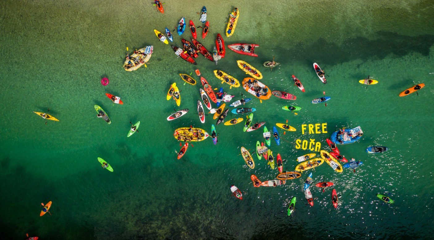 Free Soča flotilla during the fourth Balkan Rivers Tour in summer 2019 on our home river, Soča, Slovenia. A total of 150 paddlers from 23 countries joined on the reservoir behind the first of seven hydropower dams asking for the removal of the dam to expose the beautiful canyon below. Photo: Mitja Legat