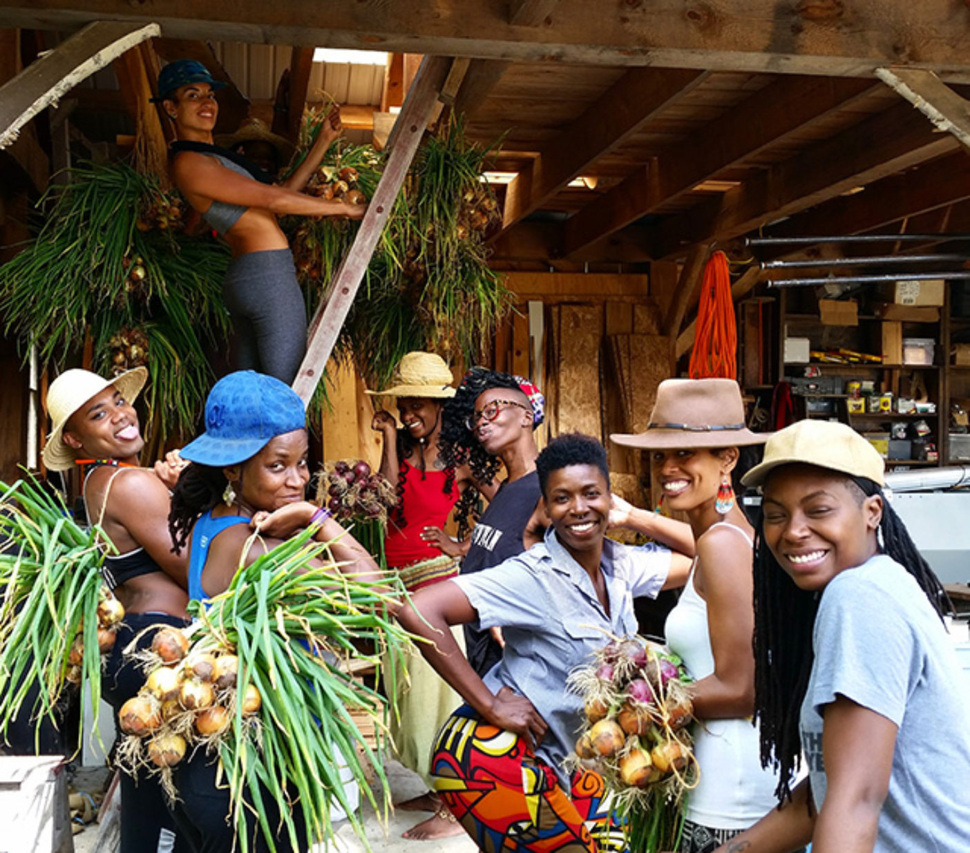 Black Latinx Farmers Immersion participants hanging onions to cure in the barn. Photo: Leah Penniman