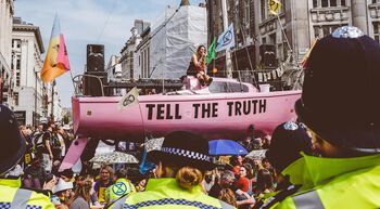 The SS Tell the Truth, launched by Extinction Rebellion (XR), gets the message across during the shutdown of Oxford Circus in London. XR demands governments tell the truth about the climate crisis, reduce greenhouse gas emissions to net zero by 2025 and convene a Citizens’ Assembly. Photo: Lauren Marina/Extinction Rebellion